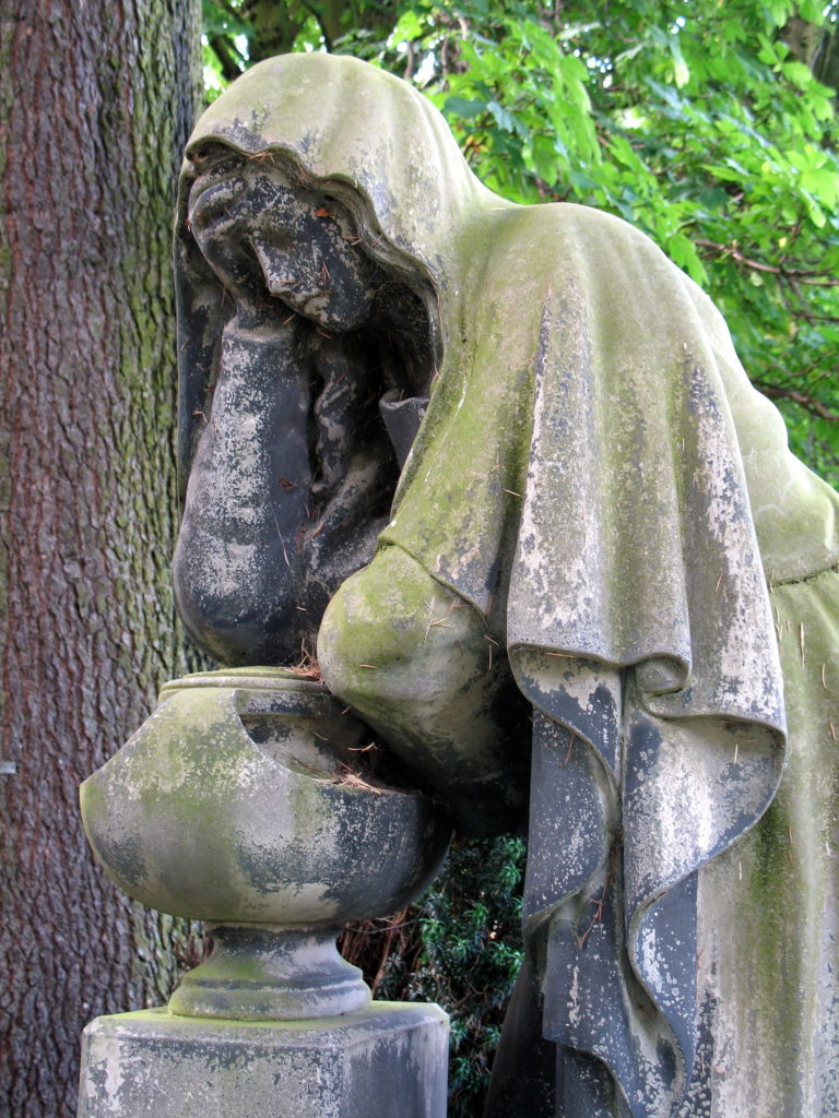 Memorial tombstone of grieving woman